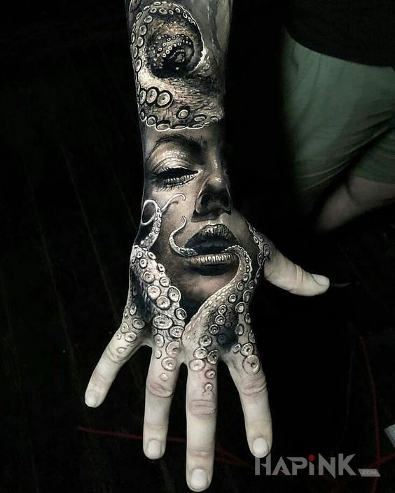 Tattoo W mackach in faces motif and realistic style on the hand