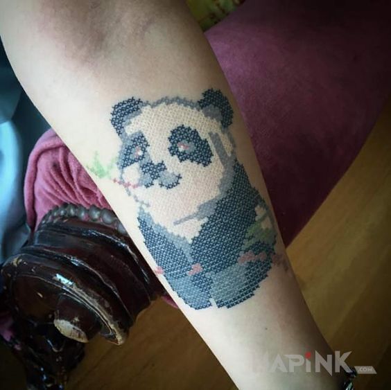 Tattoo Urocza panda in animals motif and embroidered style on the forearm