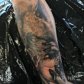 Tattoo The woman and the wolf on the forearm motif: black and gray style: realistic