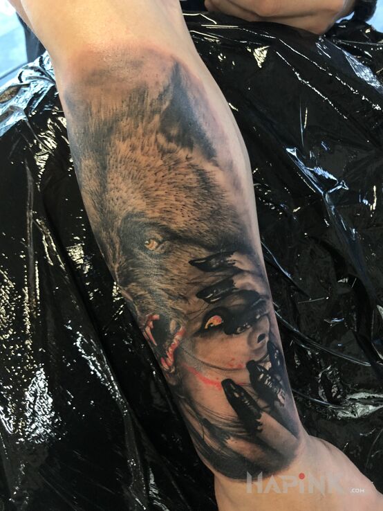 Tattoo Kobieta i wilk in black and gray motif and realistic style on the forearm