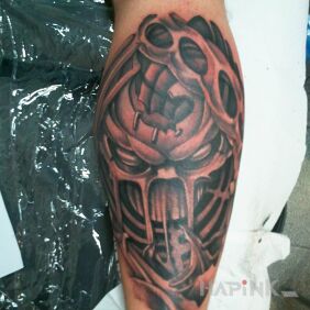 Tattoo A skull in a leg on the calf motif: black and gray style: graphic / illustrative