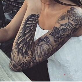 Tattoo Roses and sash on the upper arm motif: black and gray style: graphic / illustrative