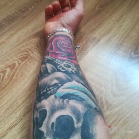 Tattoo Skull rose on the forearm motif: colorful style: realistic