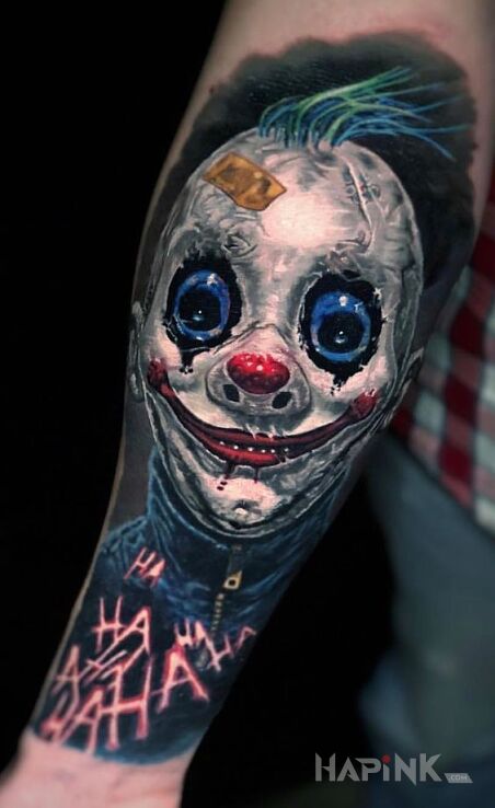 Tattoo Ty klaunie in dark motif and realistic style on the forearm