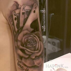 Tattoo Time is money on the upper arm motif: black and gray style: realistic