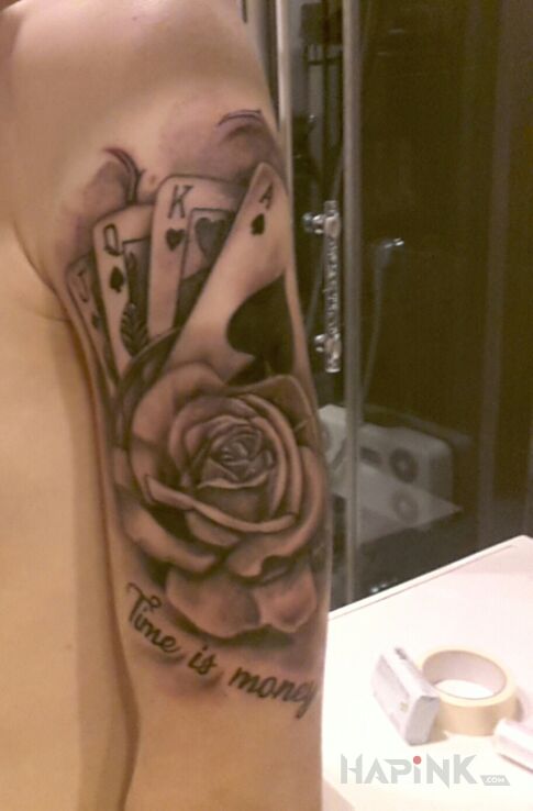 Tattoo Time is money in lettering motif and realistic style on the upper arm