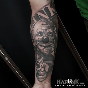 Tattoo Clown on the forearm motif: black and gray style: realistic