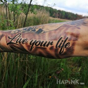 Tattoo Caption on the forearm motif: lettering style: calligraphy