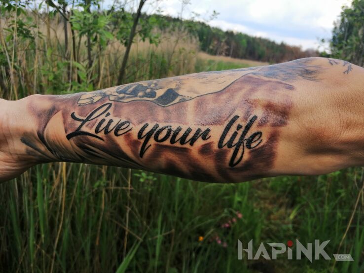 Tattoo Napis in lettering motif and calligraphy style on the forearm
