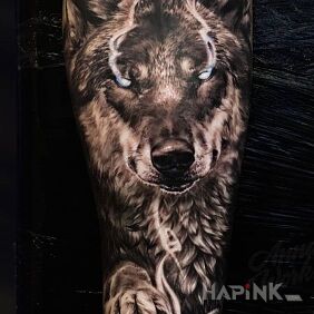 Tattoo Magic wolf on the forearm motif: black and gray style: realistic