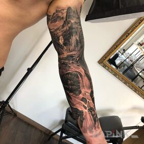 Tattoo Naturally on the upper arm motif: black and gray style: realistic