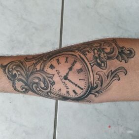 Tattoo Pocket watch on the forearm motif: black and gray style: realistic