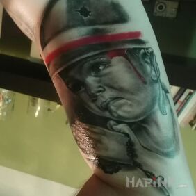 Tattoo Insurgent on the upper arm motif: religious style: realistic