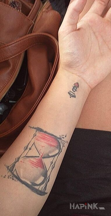 Tattoo Klepsydra,dama in black and gray motif and graphic / illustrative style on the wrist