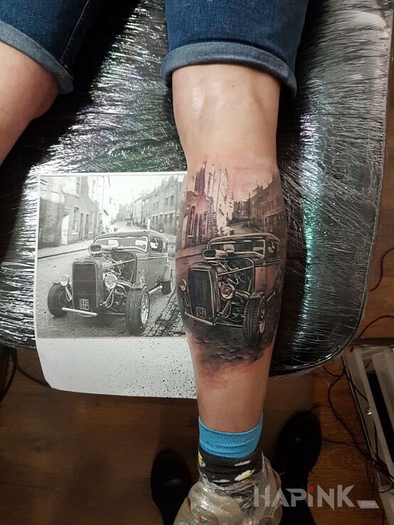 Tattoo Klasyk in black and gray motif and realistic style on the calf