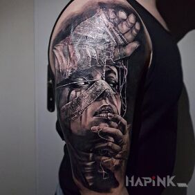 Tattoo Woman on the upper arm motif: faces style: realistic