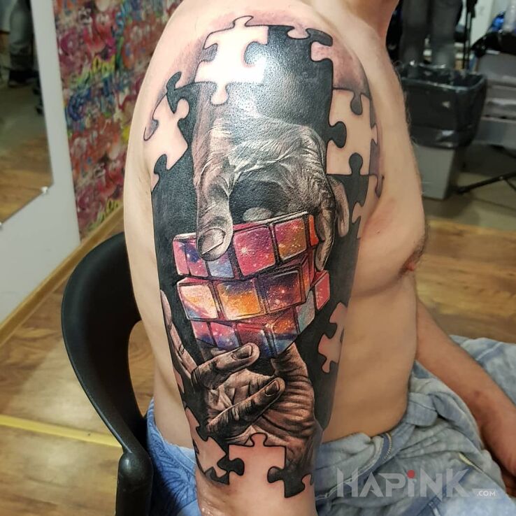 Tattoo Rubik in cosmos motif and realistic style on the upper arm