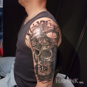 Tattoo SKULL on the upper arm motif: skulls style: realistic