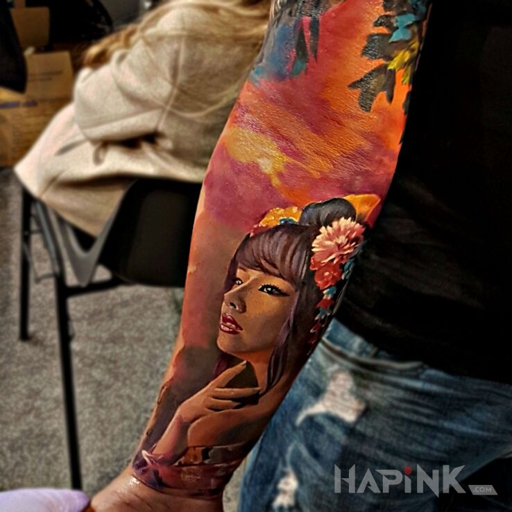 Tattoo Geisha in colorful motif and realistic style on the forearm
