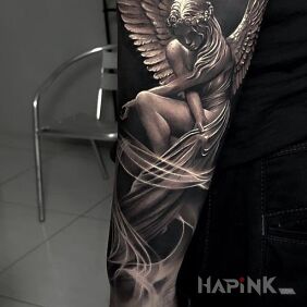 Tattoo Naked angel on the forearm motif: black and gray style: realistic