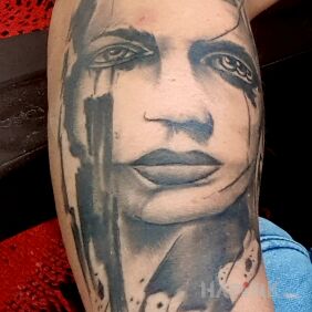 Tattoo Face on the forearm motif: black and gray style: realistic