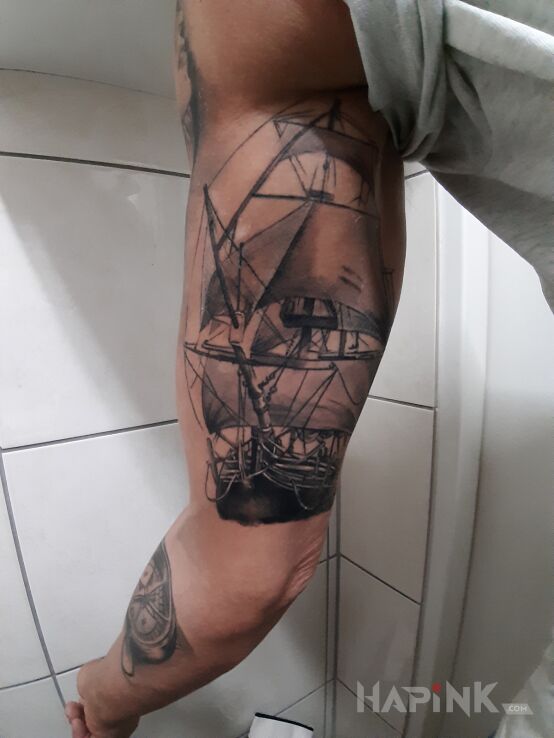 Tattoo Statek i kompas in other motif and realistic style on the upper arm