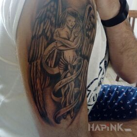 Tattoo Guardian angel on the upper arm motif: black and gray style: graphic / illustrative