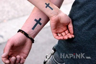 Tattoo Dwa krzyże in religious motif on the forearm