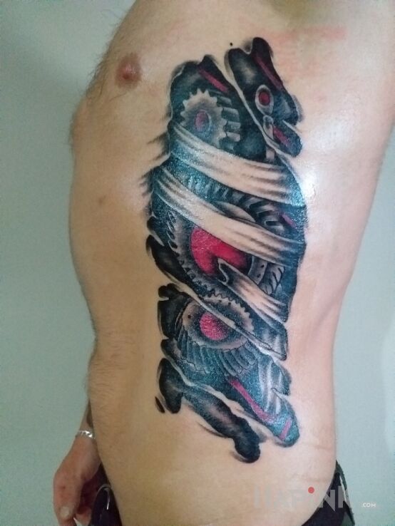 Tattoo Biomechanika in ripped skin motif and biomechanics style on the ribs