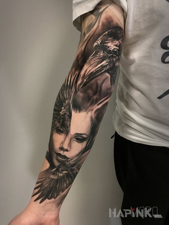 Tattoo Kobieta ze skrzydłami in black and gray motif and realistic style on the upper arm