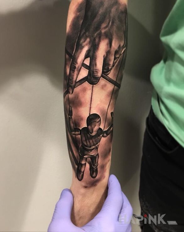Tattoo Kukiełka na linkach in objects motif and realistic style on the forearm