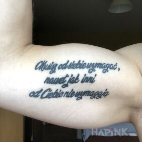 Tattoo Sentence on the upper arm motif: lettering style: calligraphy