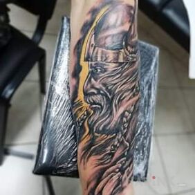 Tattoo Viking veteran on the forearm motif: black and gray style: graphic / illustrative