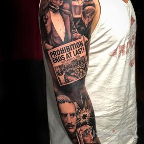 Tattoo La mafia on the upper arm motif: black and gray style: realistic