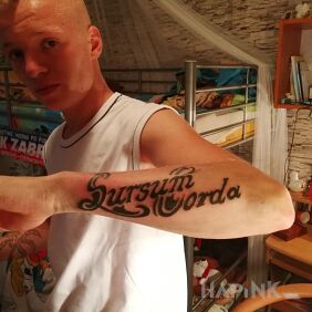 Tattoo Second finished on the forearm motif: lettering style: calligraphy